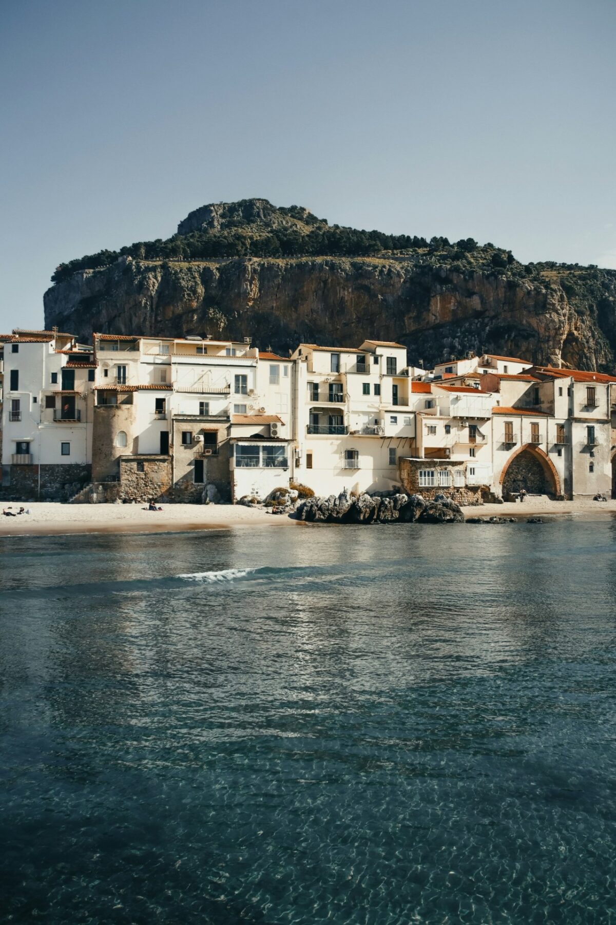 tenniswood:

A row of light-colored buildings with red-tiled…